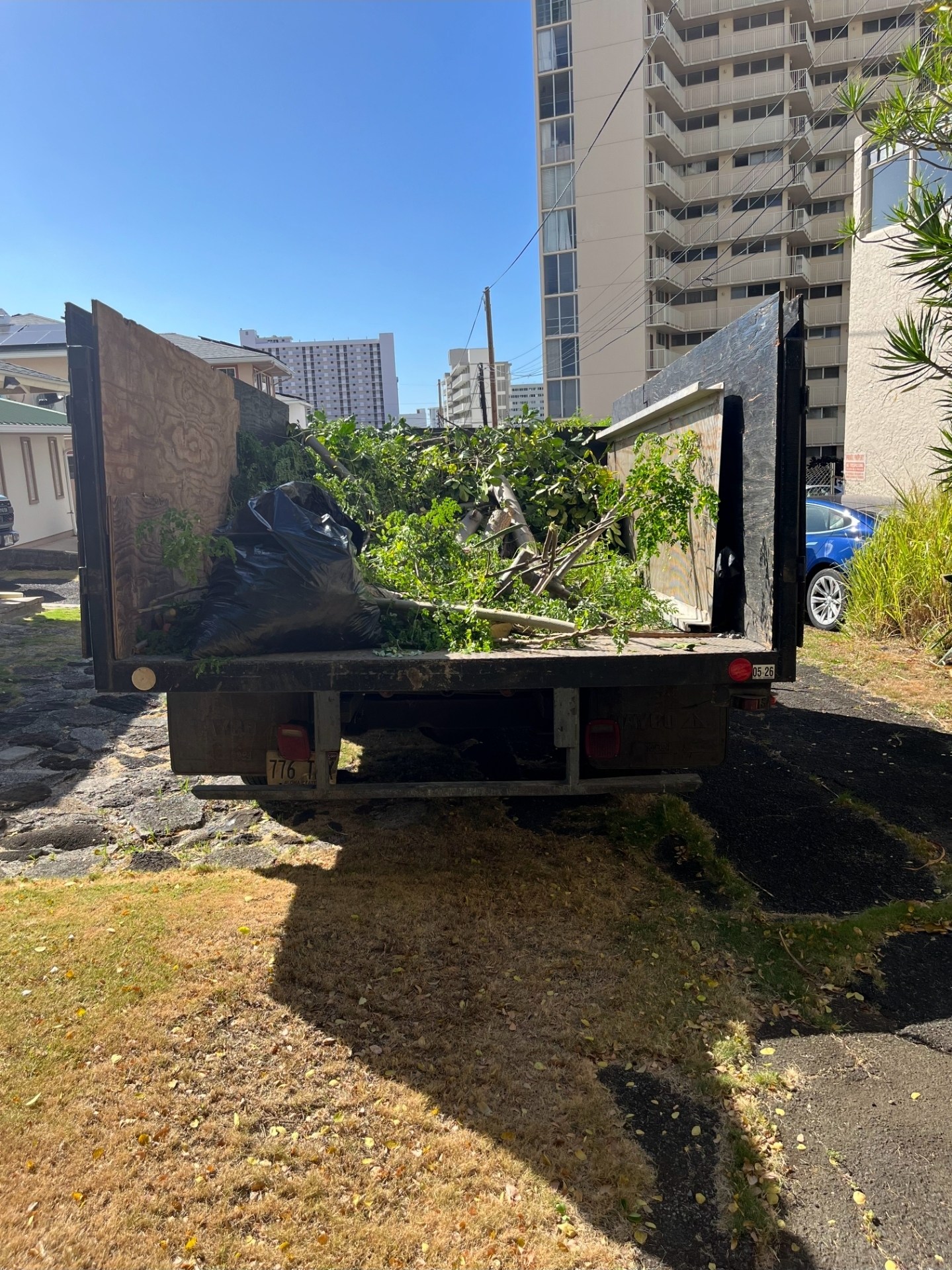 Professional landscaper in uniform operating equipment on residential property