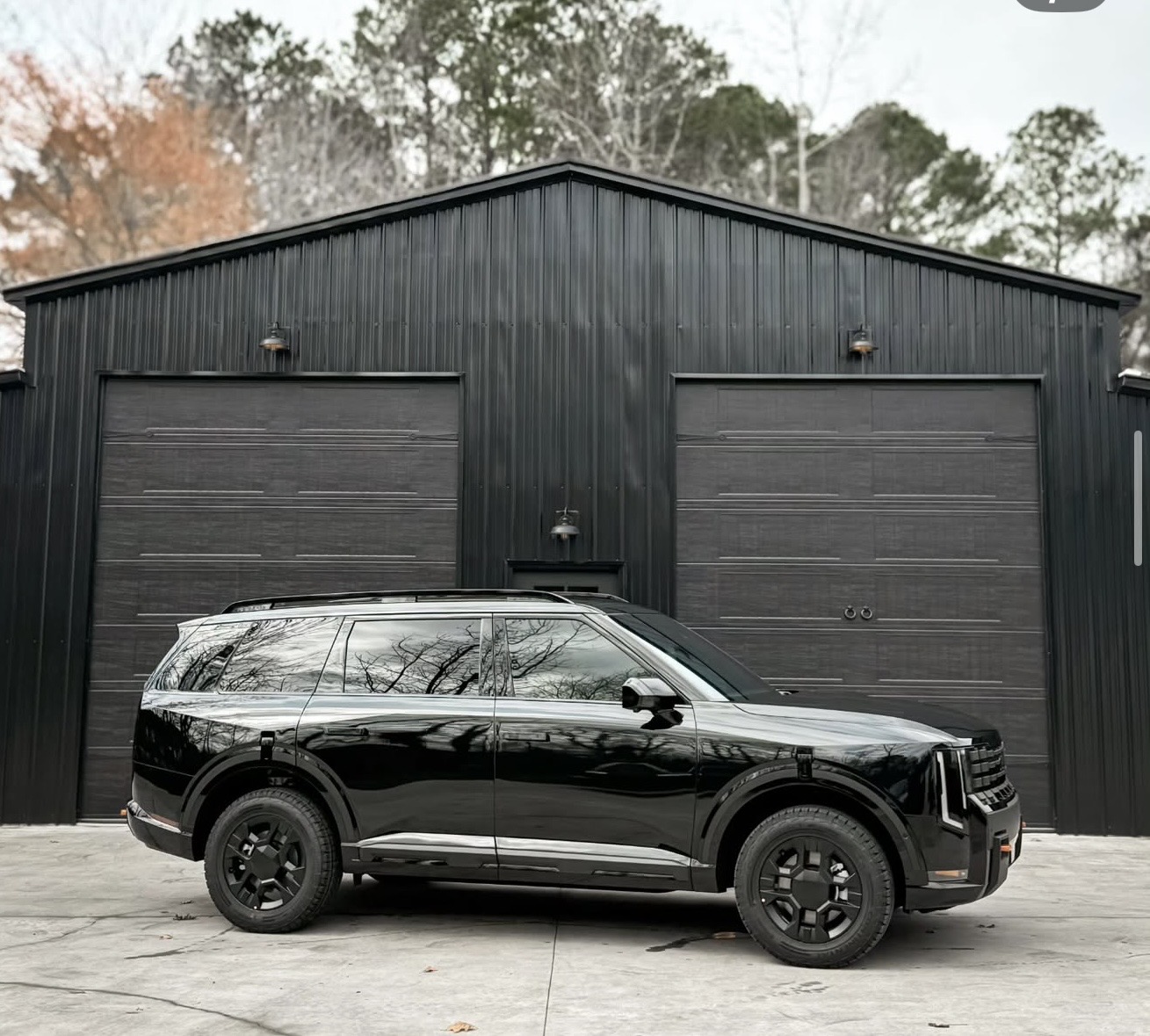 High-end sports car receiving meticulous bespoke detailing, ceramic coating, and paint protection film in Graner's Garage