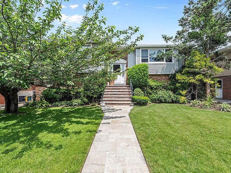 Modern kitchen featuring deep timber brown cabinetry, aged brass fixtures, and rustic stone countertops