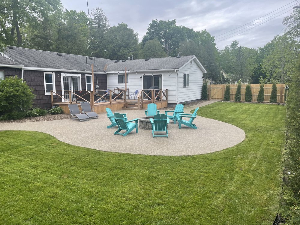 Stamped concrete patio with intricate decorative pattern in a luxury backyard