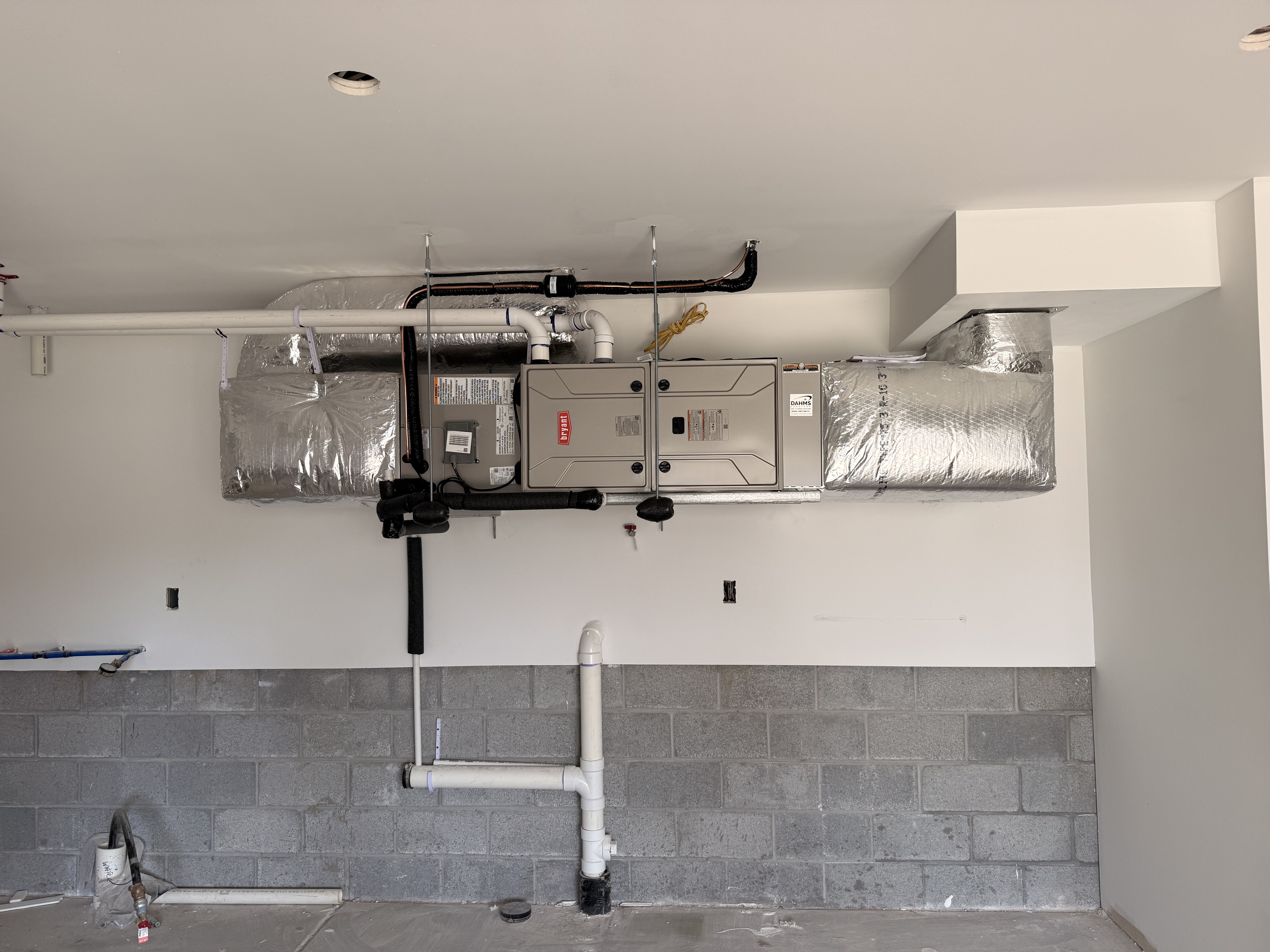 Ductless mini split heat pump installation on residential wall