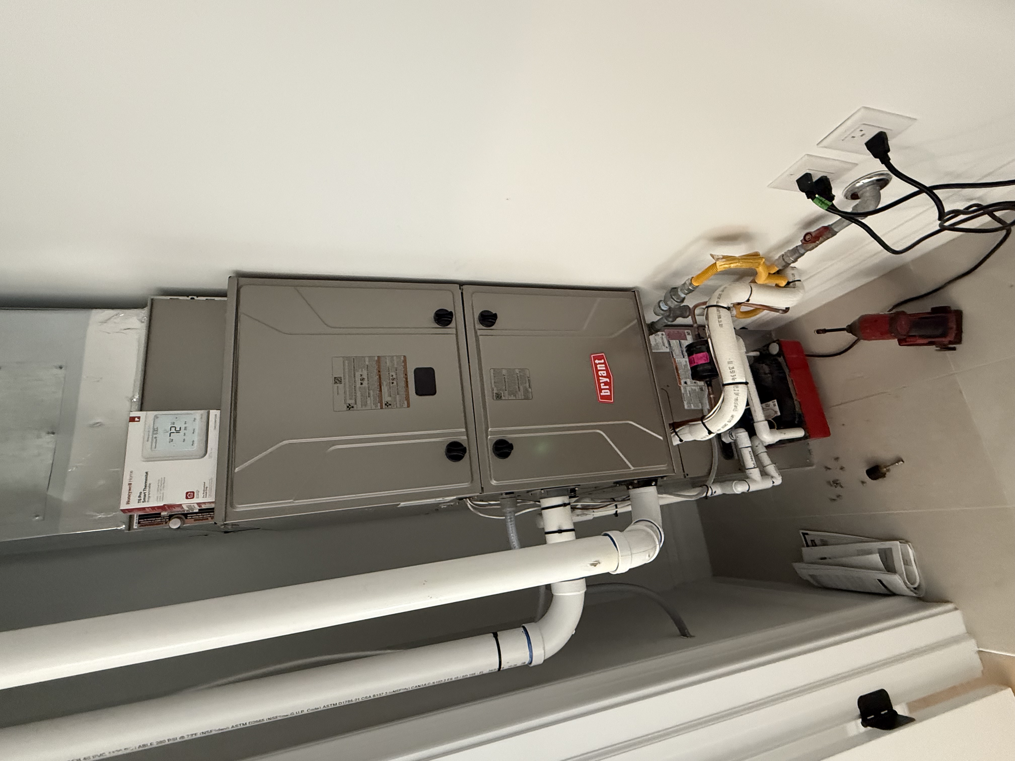 HVAC technician performing heat pump installation at coastal New Jersey home