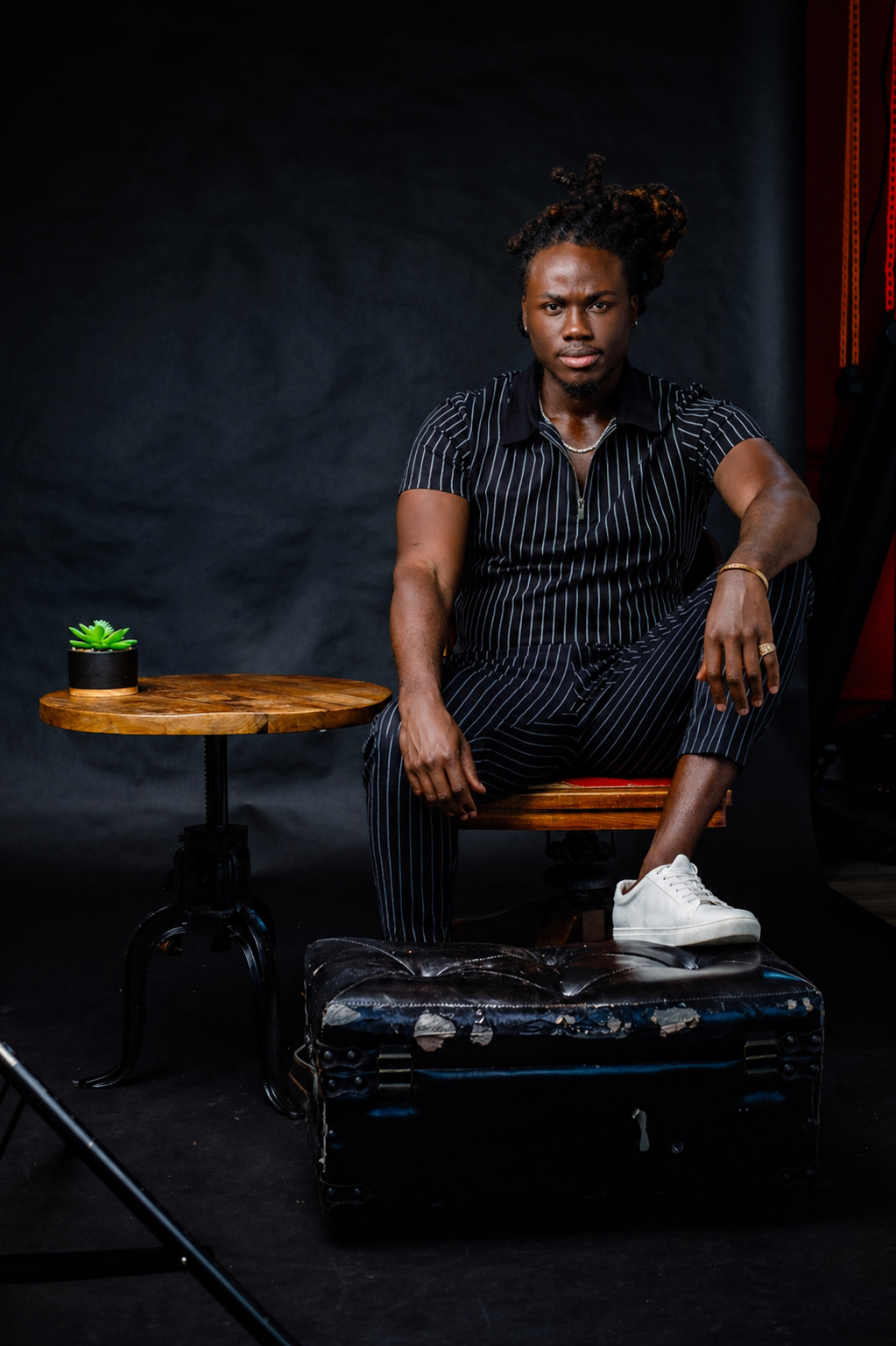 Antwan Daceus professional headshot in tailored suit against minimalist backdrop