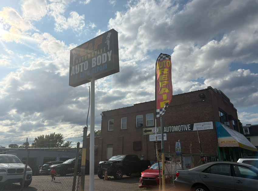 Professional mechanic repairing a vehicle engine in a rugged auto shop