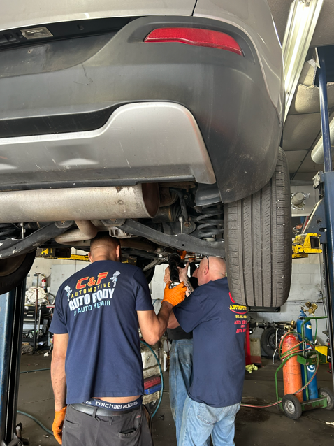 Detailed multi-point vehicle inspection checklist being completed by a certified mechanic