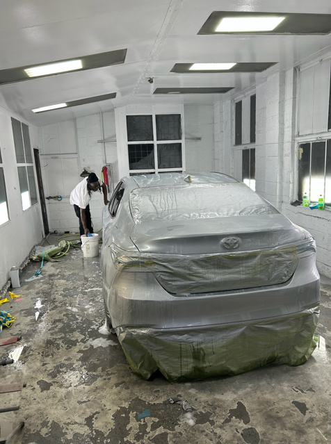 Vehicle inside professional paint booth at C&F Automotive in Hartford