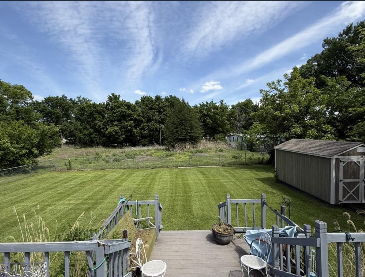 Close-up showing sharp, crisp edging along a concrete driveway and garden bed completed by Dill's Lawn Care