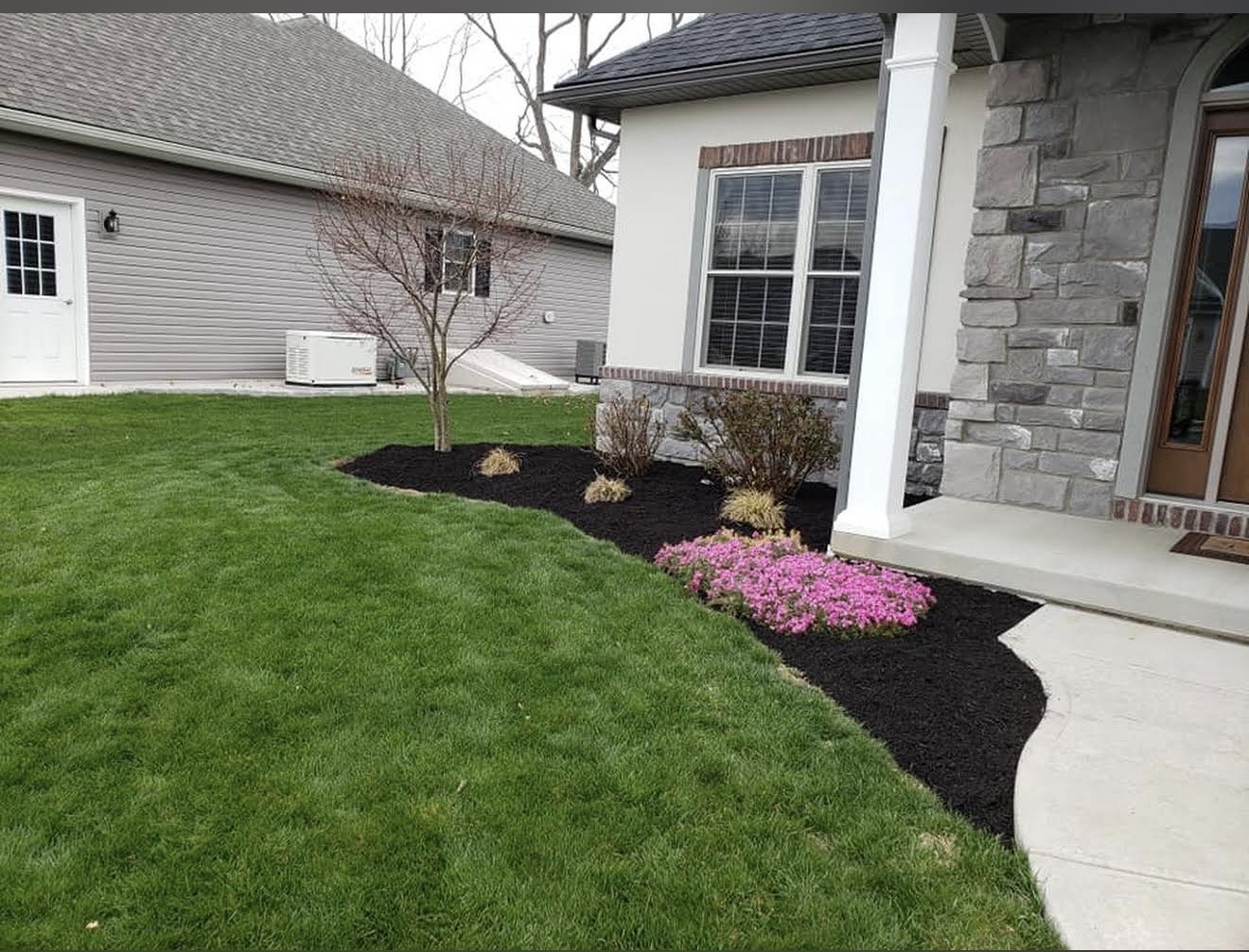 A perfectly striped, vibrant green lawn freshly mowed by professionals