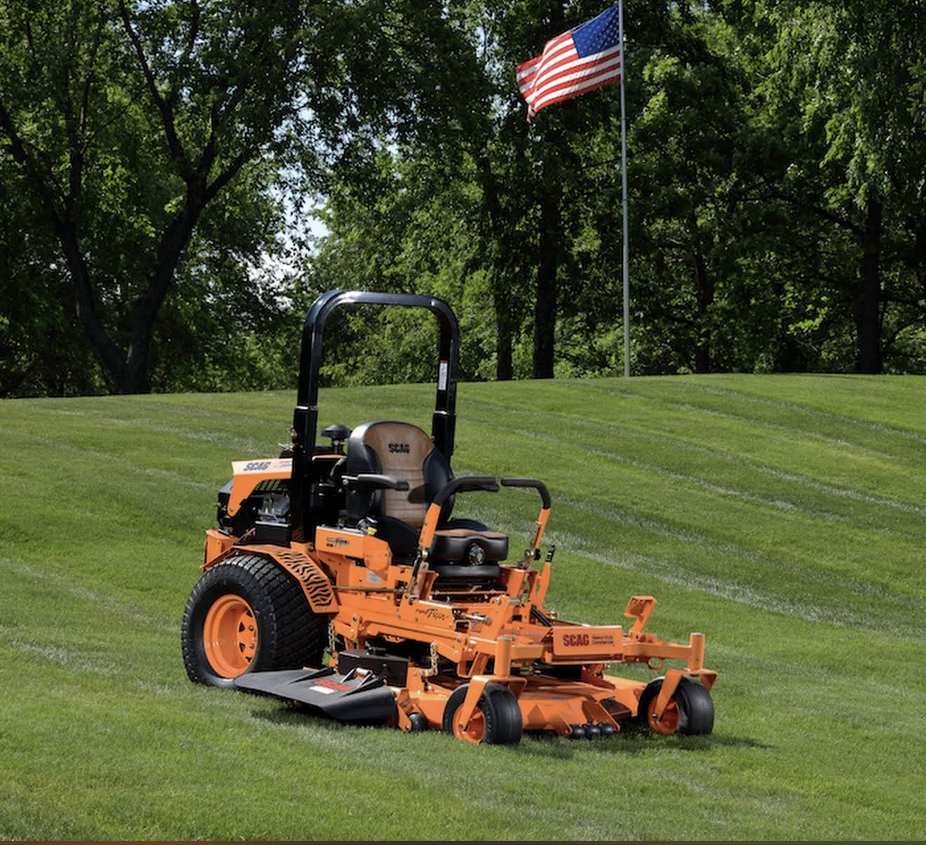 Professional landscaper standing proudly on a beautifully maintained lawn
