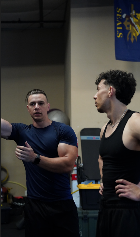 Fitness coach writing training goals in journal