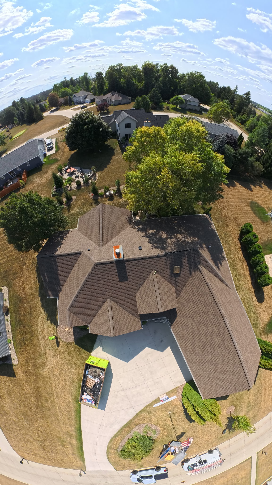 Topline Roofing Services crew installing premium asphalt shingles on a Wisconsin residential home