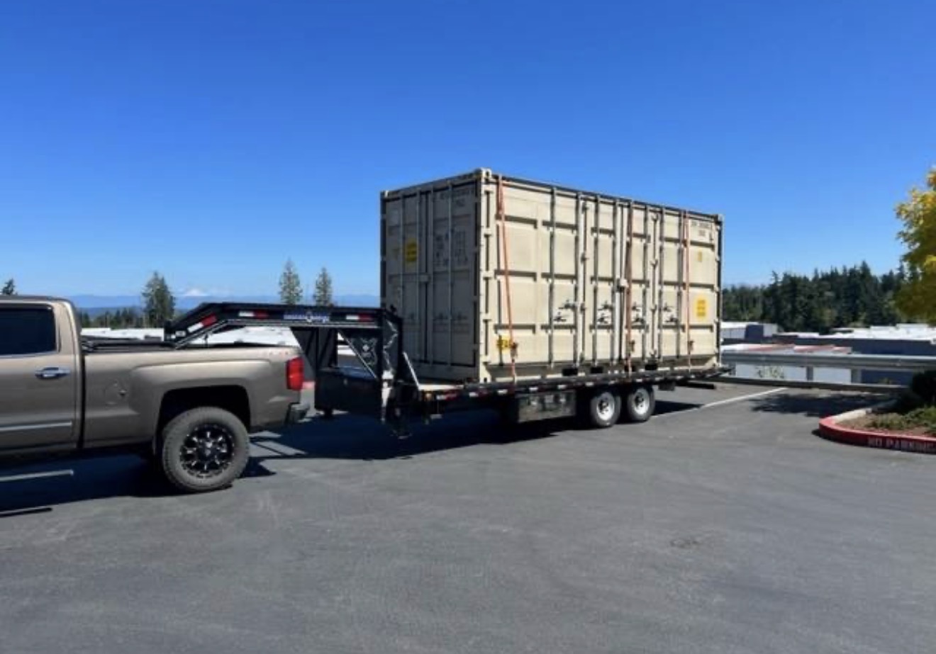 Excavator securely strapped to a transport truck for a construction project