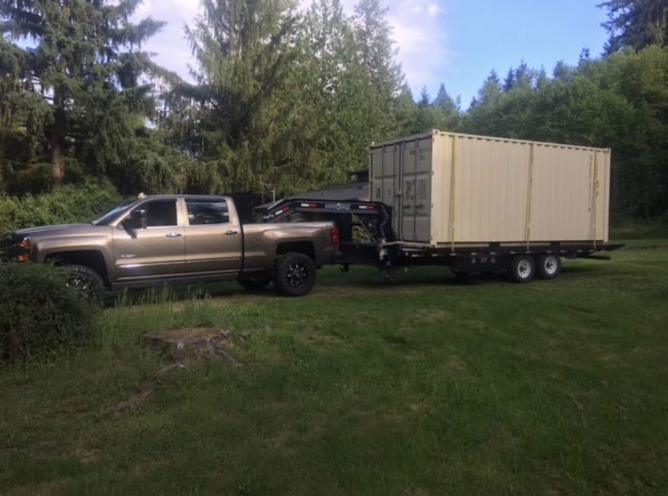 Stacks of fresh lumber being transported by an Active Transport truck at dawn