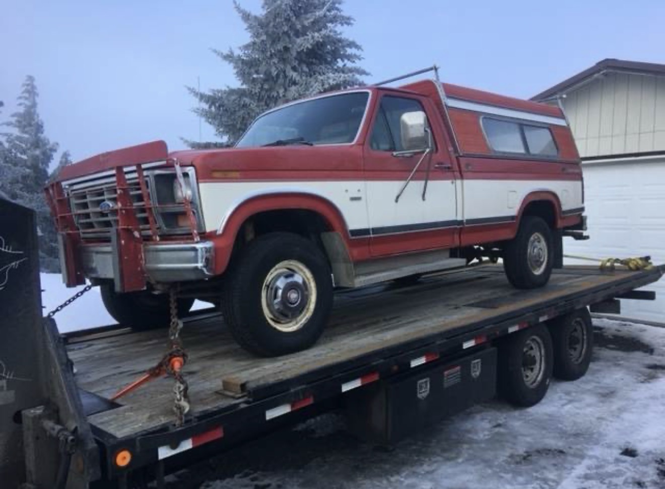 20-foot shipping container being loaded onto an Active Transport flatbed trailer