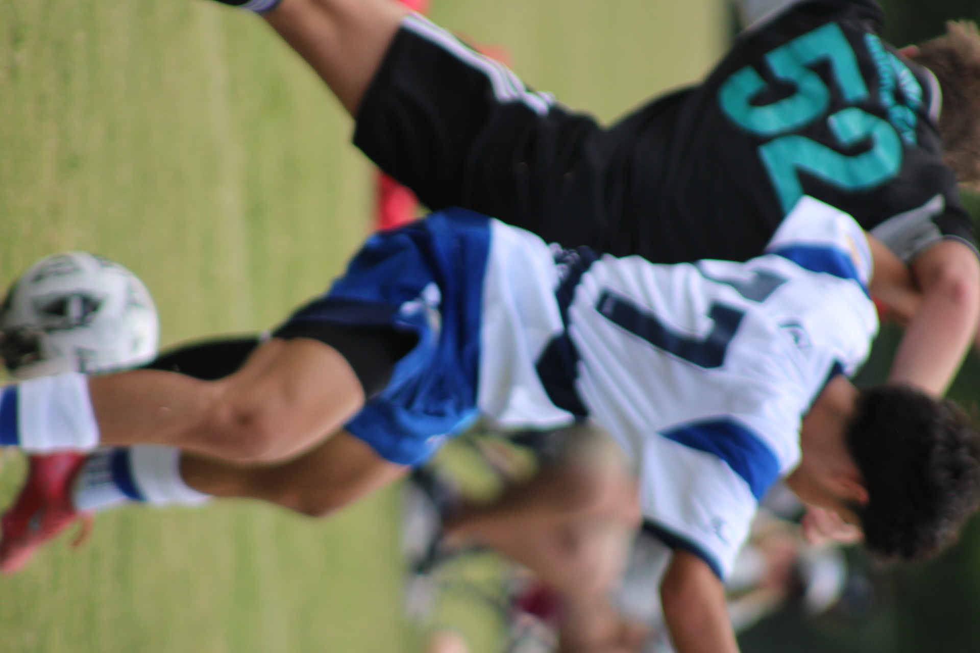 Youth soccer players competing fiercely in a high-level showcase tournament game