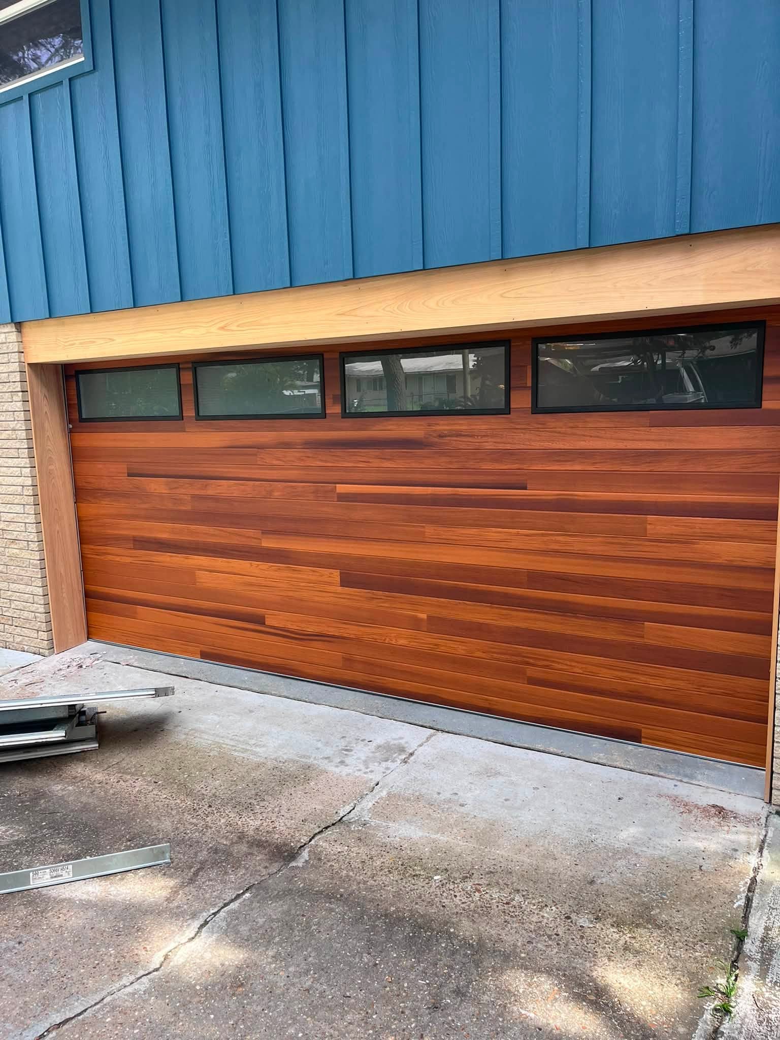Custom wood-style garage door with upper windows