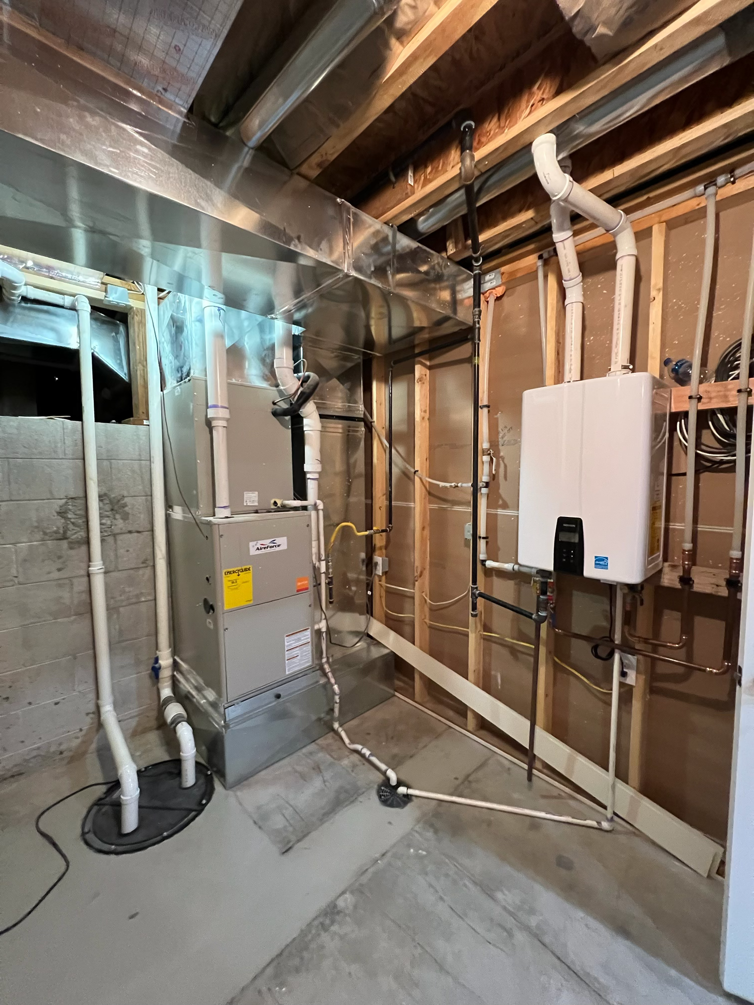 Professional plumber fixing under sink pipes in residential home