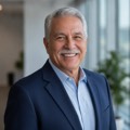Headshot of a happy senior man in his late 70s