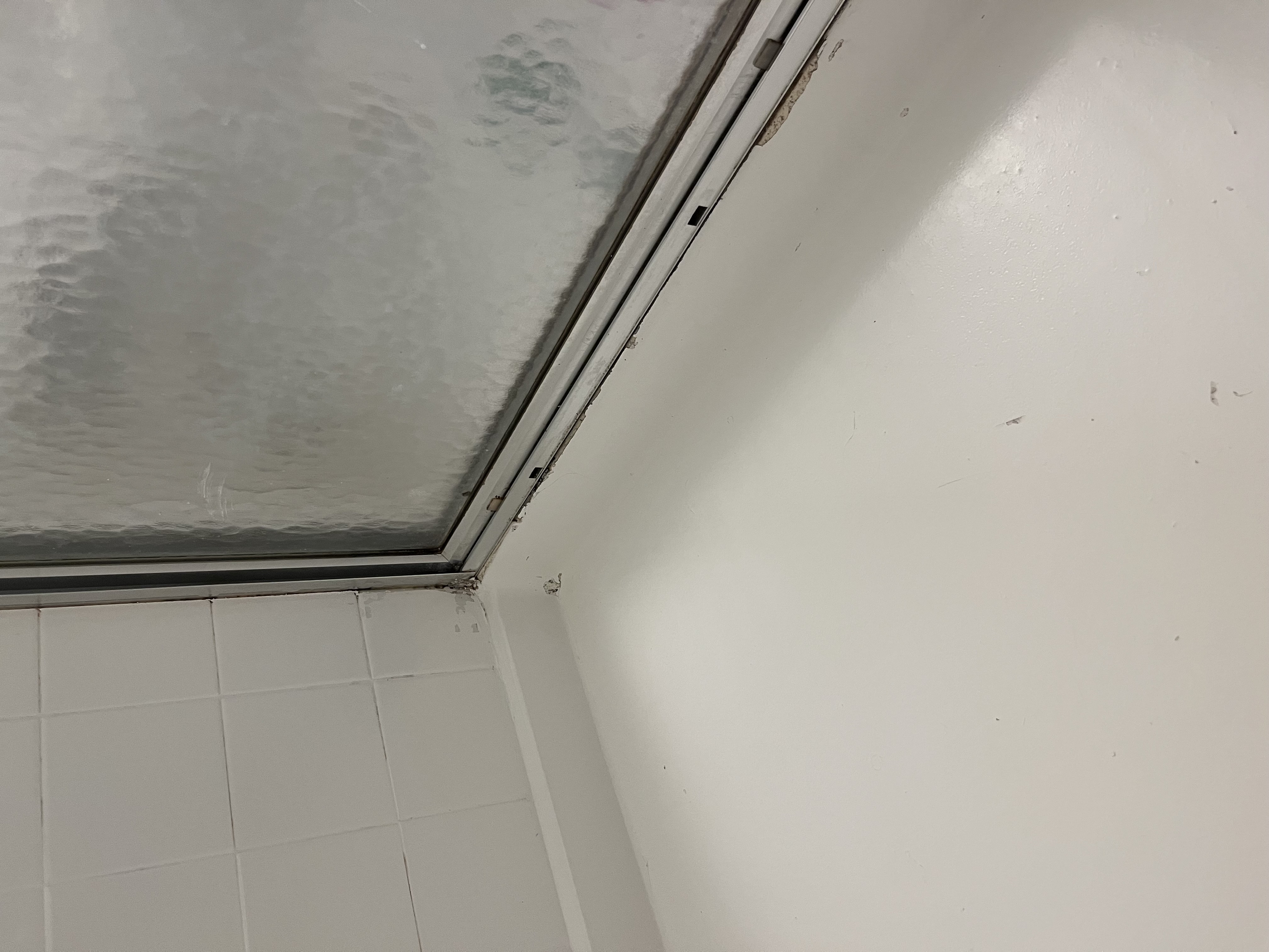 Spa-like sanitized bathroom with sparkling tile and crystal clear glass shower after professional cleaning