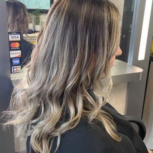 Beautiful seamless blonde balayage hair color transformation by expert stylist at Blown Away