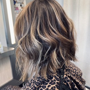 Fresh, bouncy blowout and layered haircut on a happy client in Roswell salon