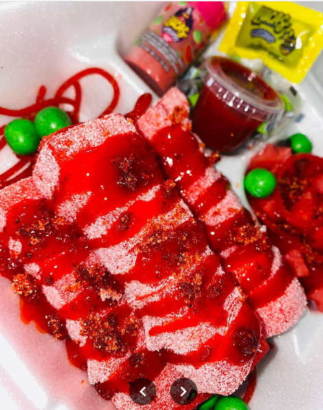 Handcrafted strawberry paleta popsicle with real fruit pieces on wooden board