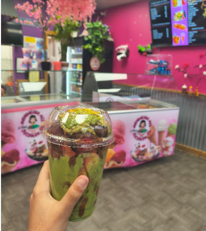 Colorful vibrant interior of La Real Michoacana Texoma paleteria with pink and yellow decor