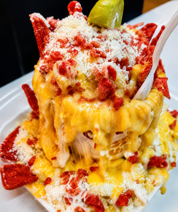 Traditional Mexican elote in a cup topped with mayo cotija cheese and chili powder