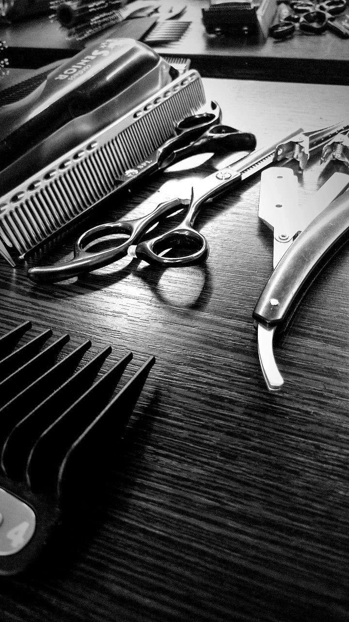 Premium dark luxury barbershop interior with gold accents and leather chairs