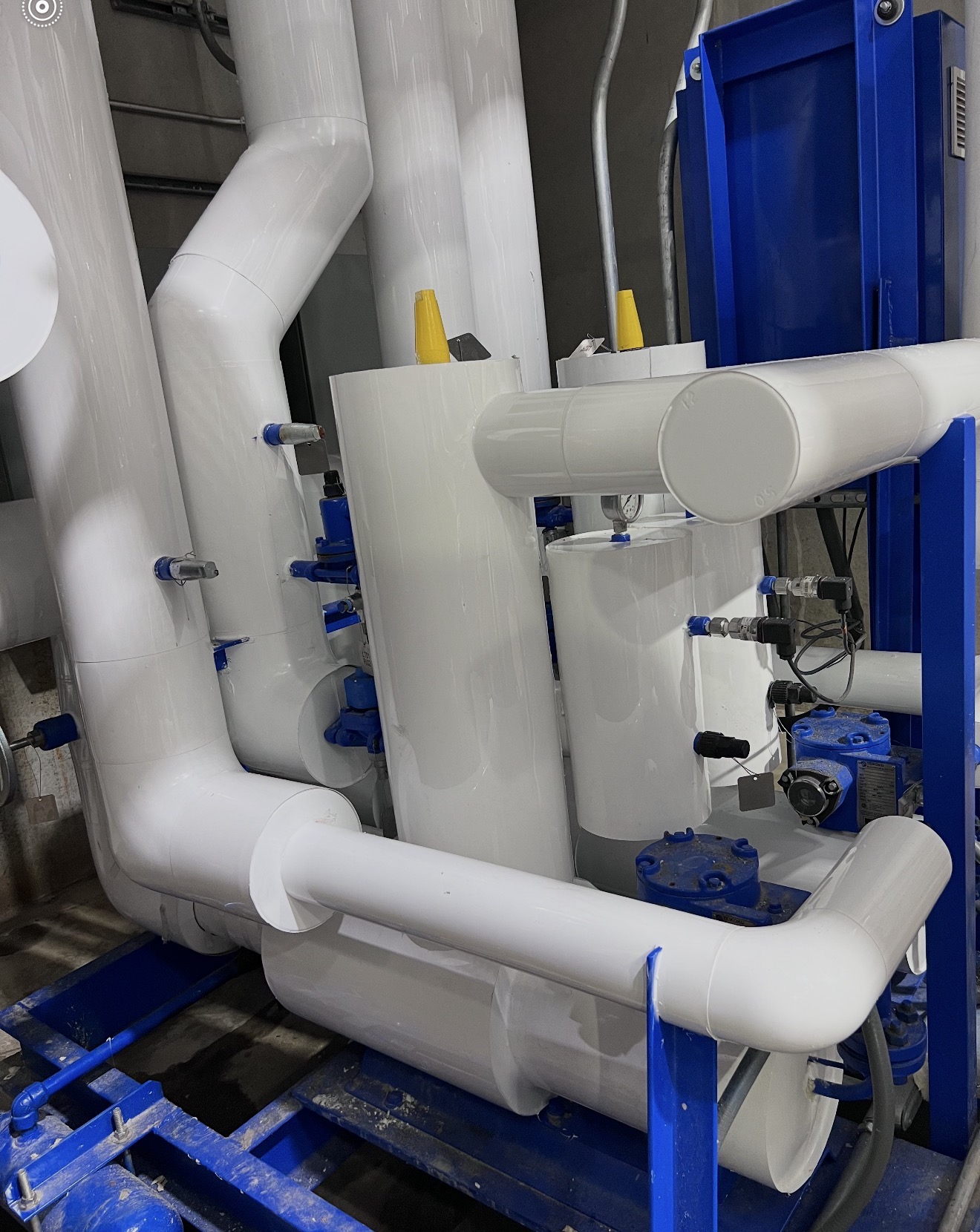 A custom-fit, removable blanket insulation system wrapped around a large industrial vessel for maintenance access.