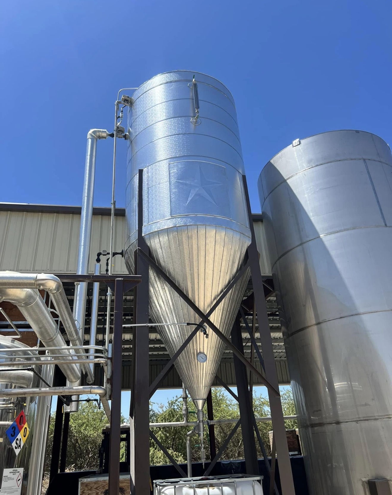 Newly insulated ammonia pipelines in a large industrial refrigeration plant, showing clean jacketing and precise fittings.