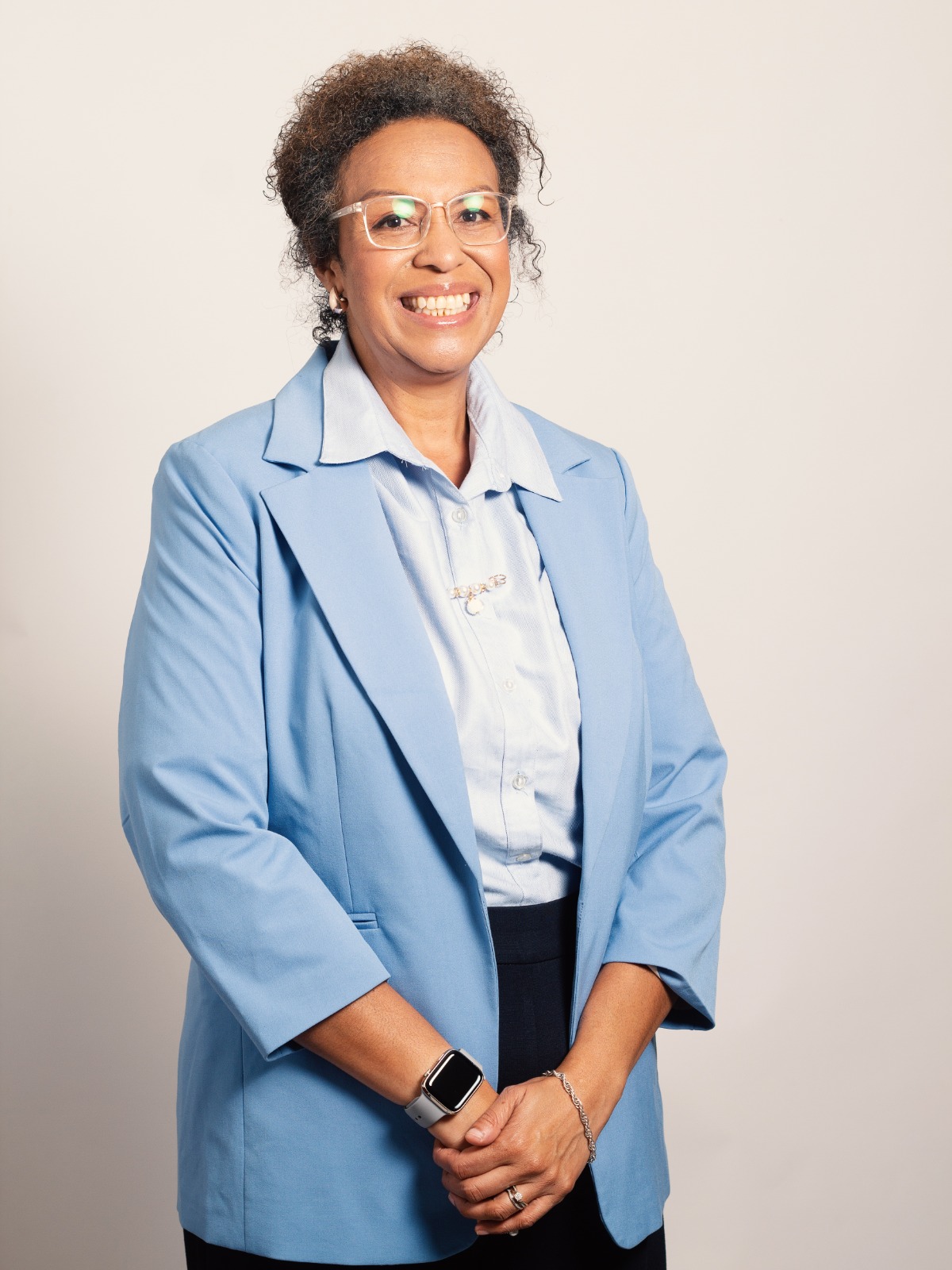 Pansy Taueni-Sialis, Principal Consultant of REL-8 HR Consultancy, standing confidently in a light blue blazer — a professional full-body portrait