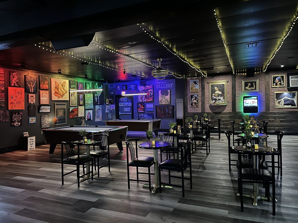 Luxurious and moody artistic interior of The Gallery Bar lounge with gold accents