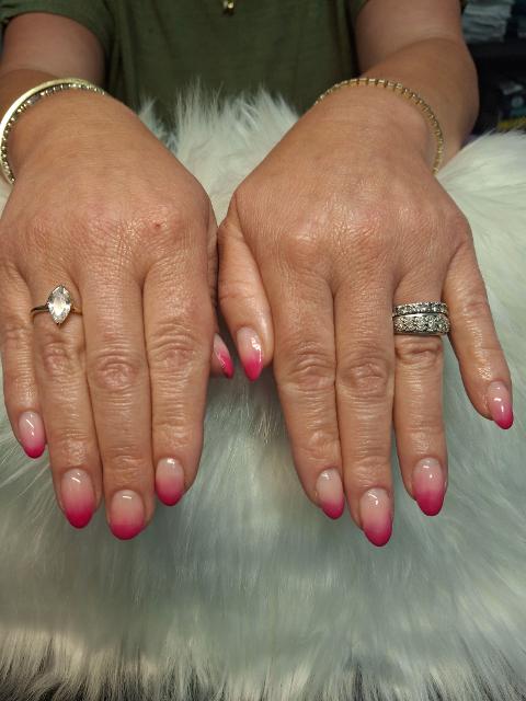 Elegant close-up of a beautifully manicured hand featuring flawless custom nail art by Carissa, showcasing intricate detail, glossy finish, and luxurious salon craftsmanship.