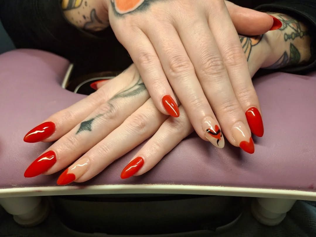 Close-up of a flawless gel manicure with almond-shaped nails in soft nude tones being finished by Carissa with a precision brush.