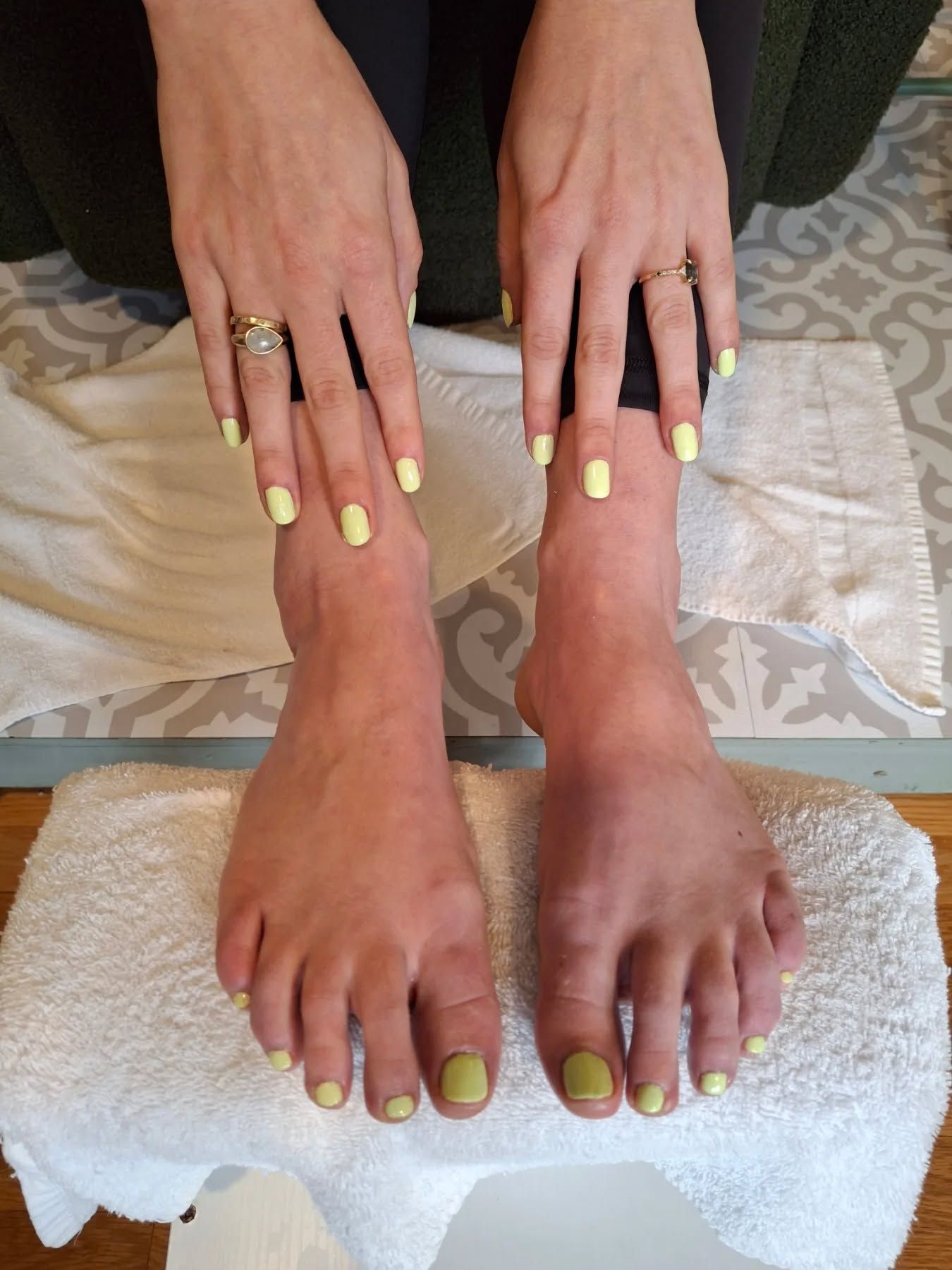Modern French tip coffin nails with delicate gold foil accents and glossy top coat by Nails by Carissa.