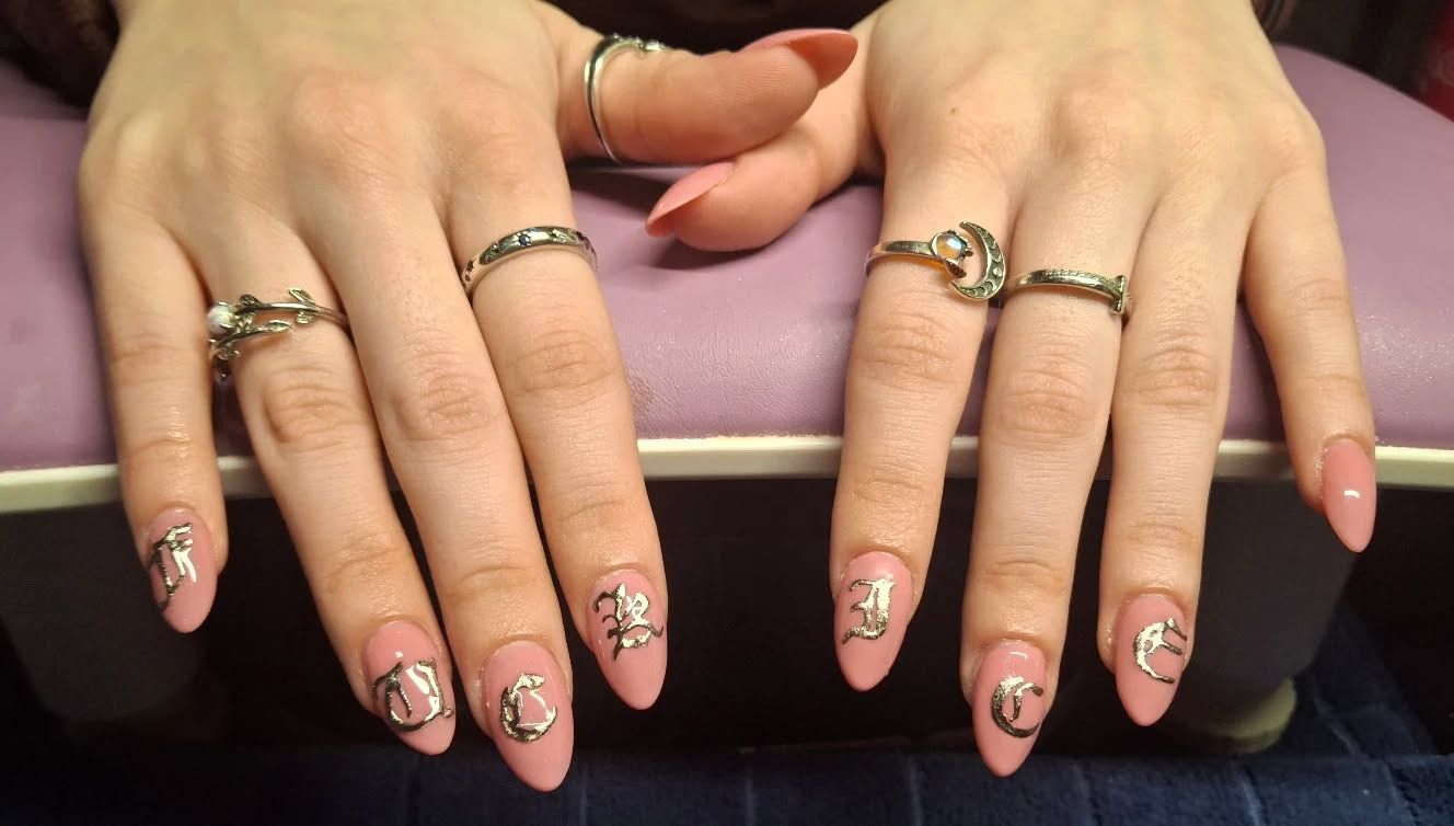 Elegant marble swirl nail art design featuring silver veining on a soft ivory base by Carissa.