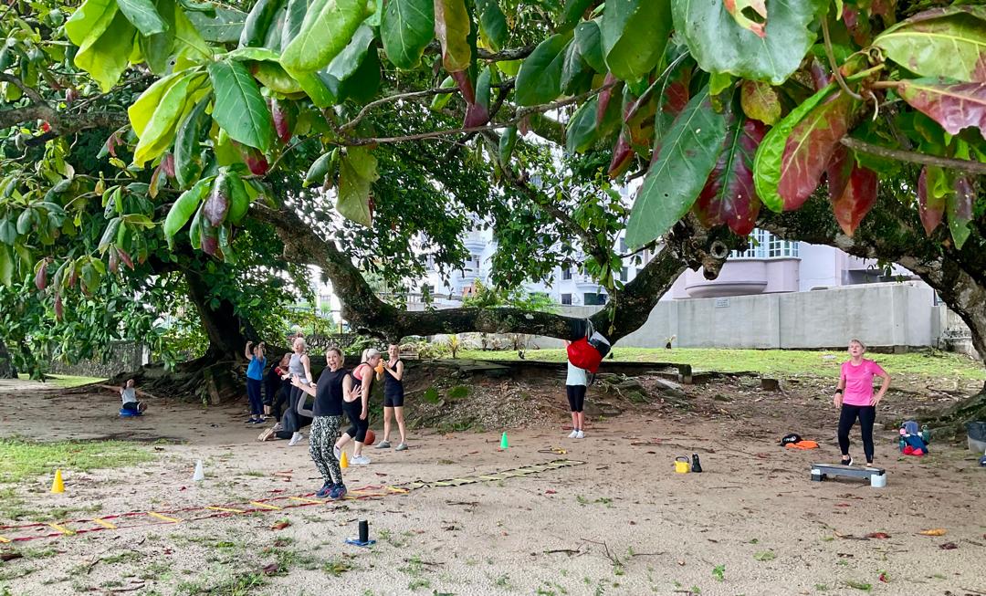 Women performing kettlebell swings during Tabata training outdoors