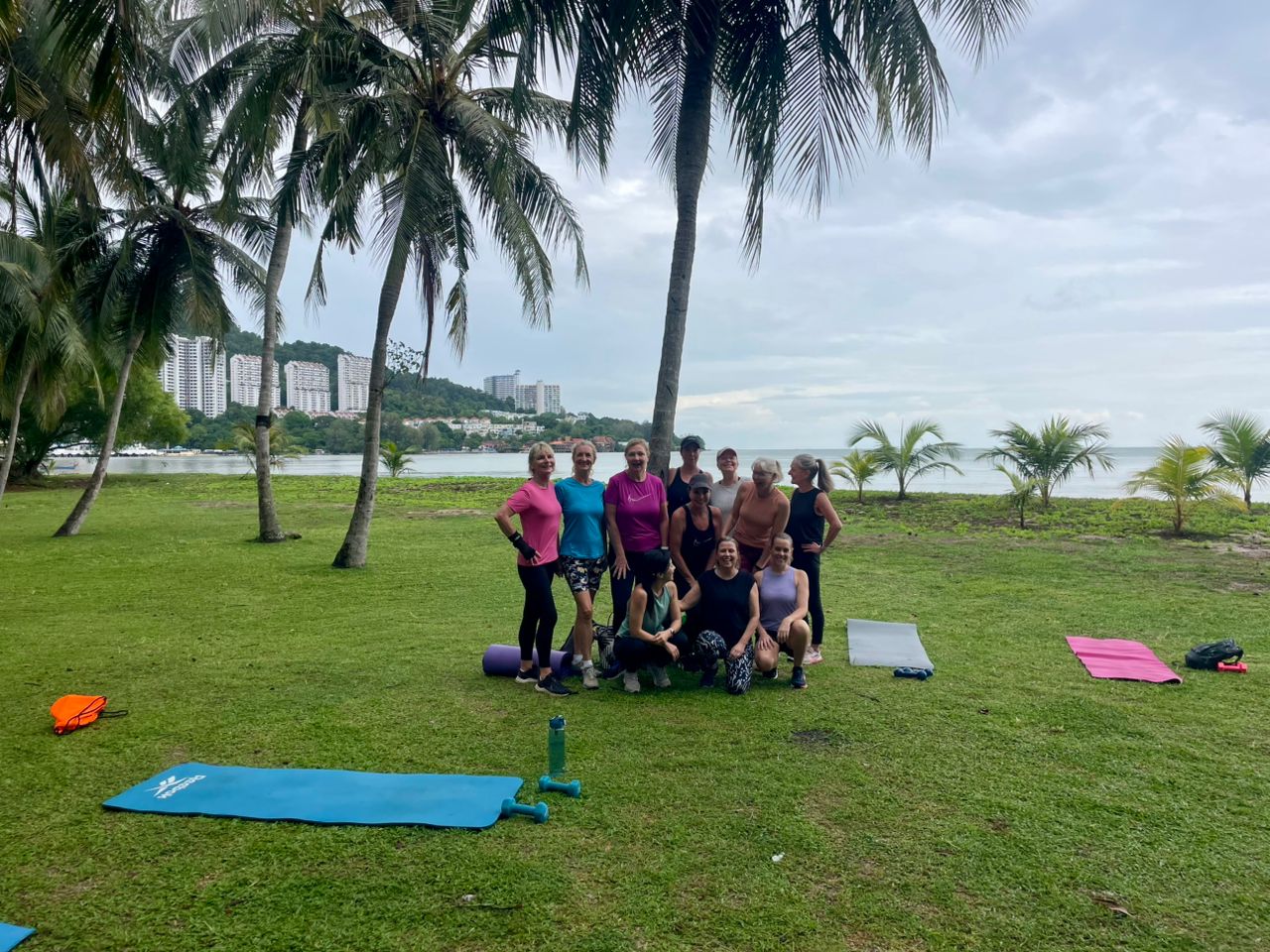 Women doing sprint drills on Batu Ferringhi beach at sunrise