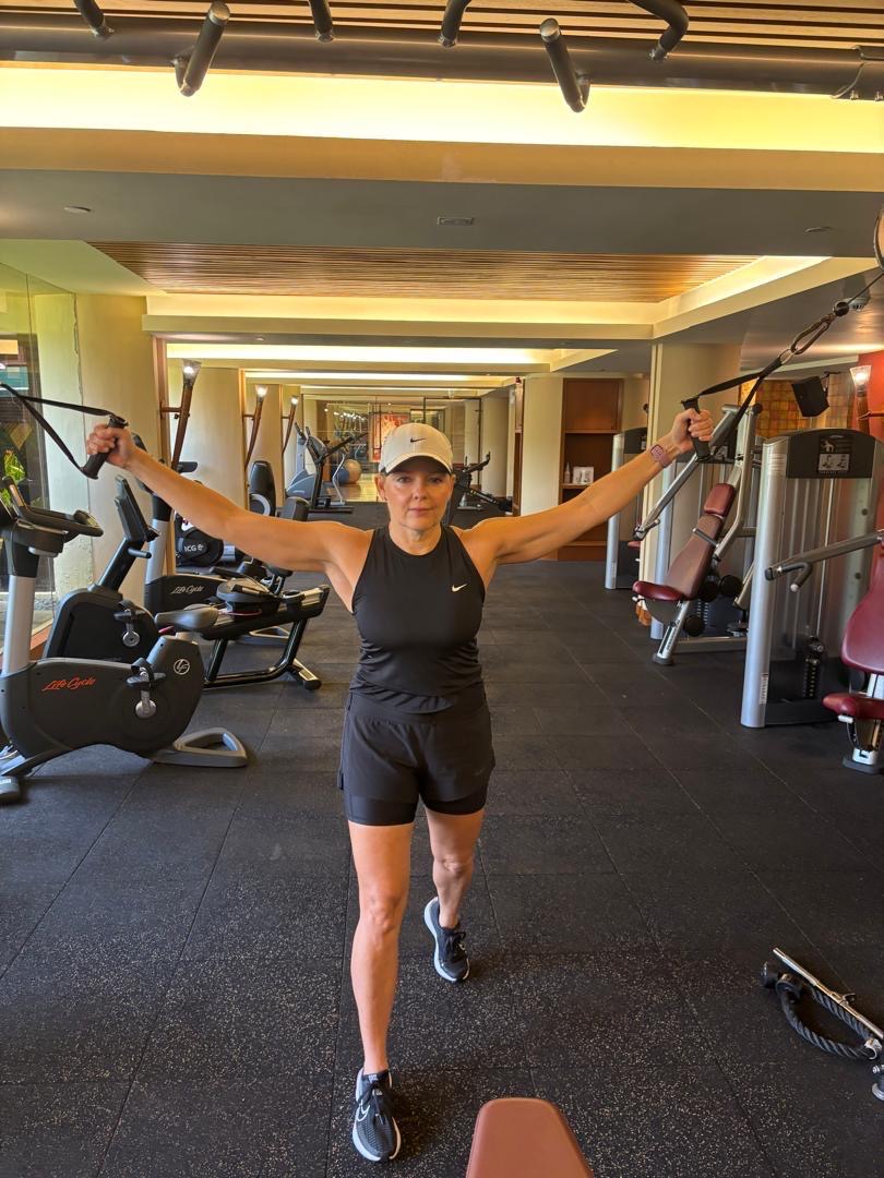 Private kettlebell training session with female coach in indoor women's gym
