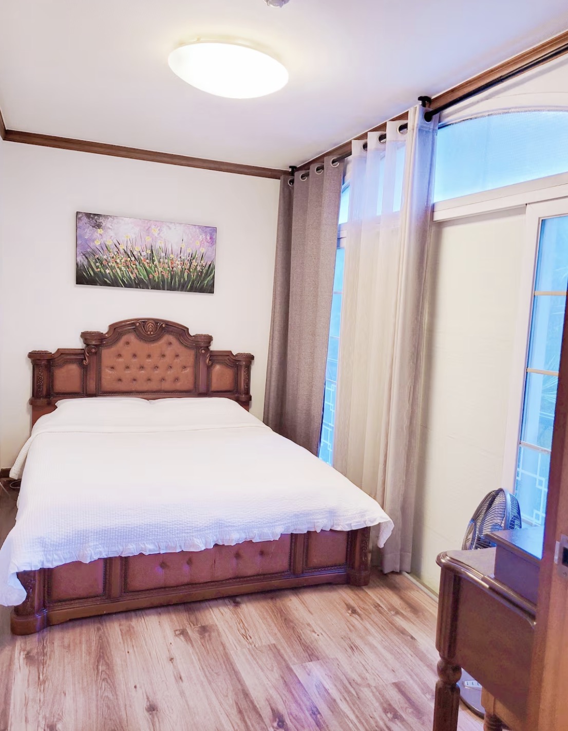 A beautifully decorated, cozy bedroom with two single beds, soft lighting, and elegant, minimalist decor.