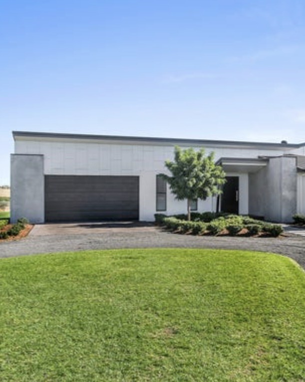 Luxury landscaped hinterland garden retreat with native flora, stone pathways and timber decking crafted by Hinterland Building