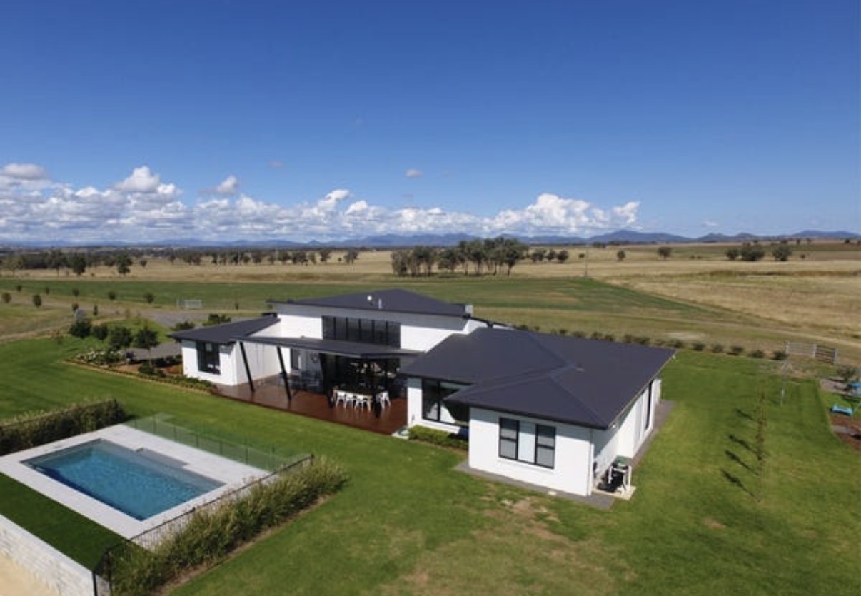 Sunshine Coast alfresco terrace featuring an outdoor kitchen, lounge seating and pergola for luxury outdoor entertaining