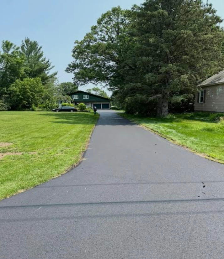 Smooth black asphalt driveway with clean edge work in New Hampshire