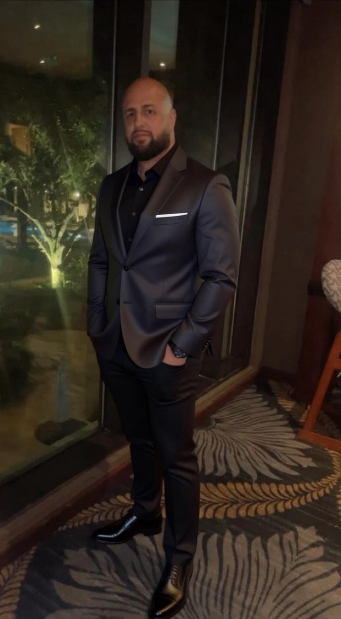 Jordan, a former law enforcement officer and founder of MavTrust Sites, standing confidently.