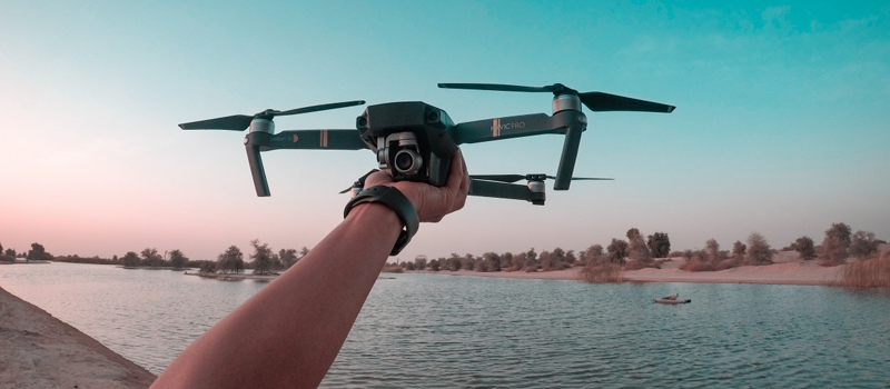 Professional drone pilot operating a controller with a focused expression