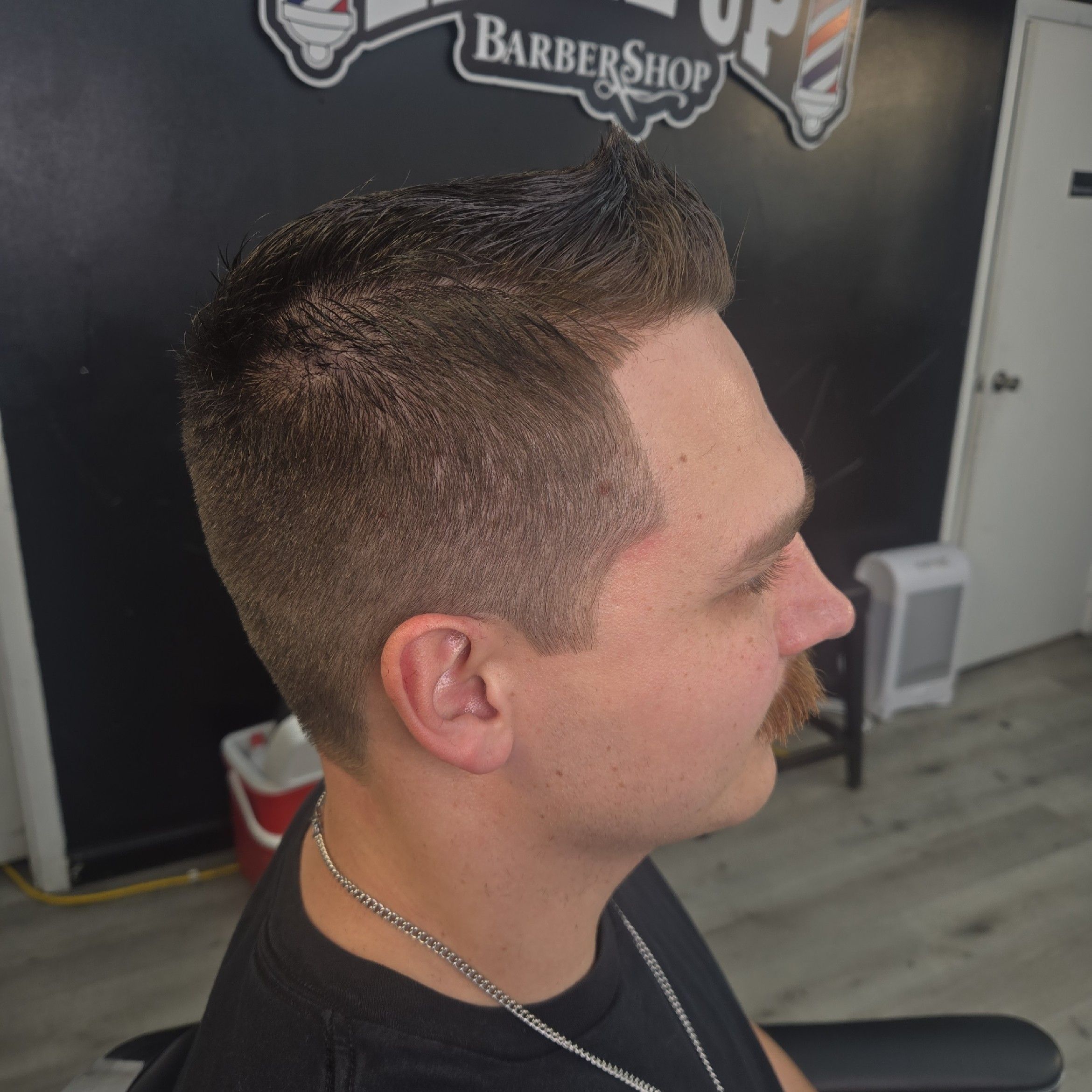 Premium dark-themed interior of Precision Luxe Barbershop
