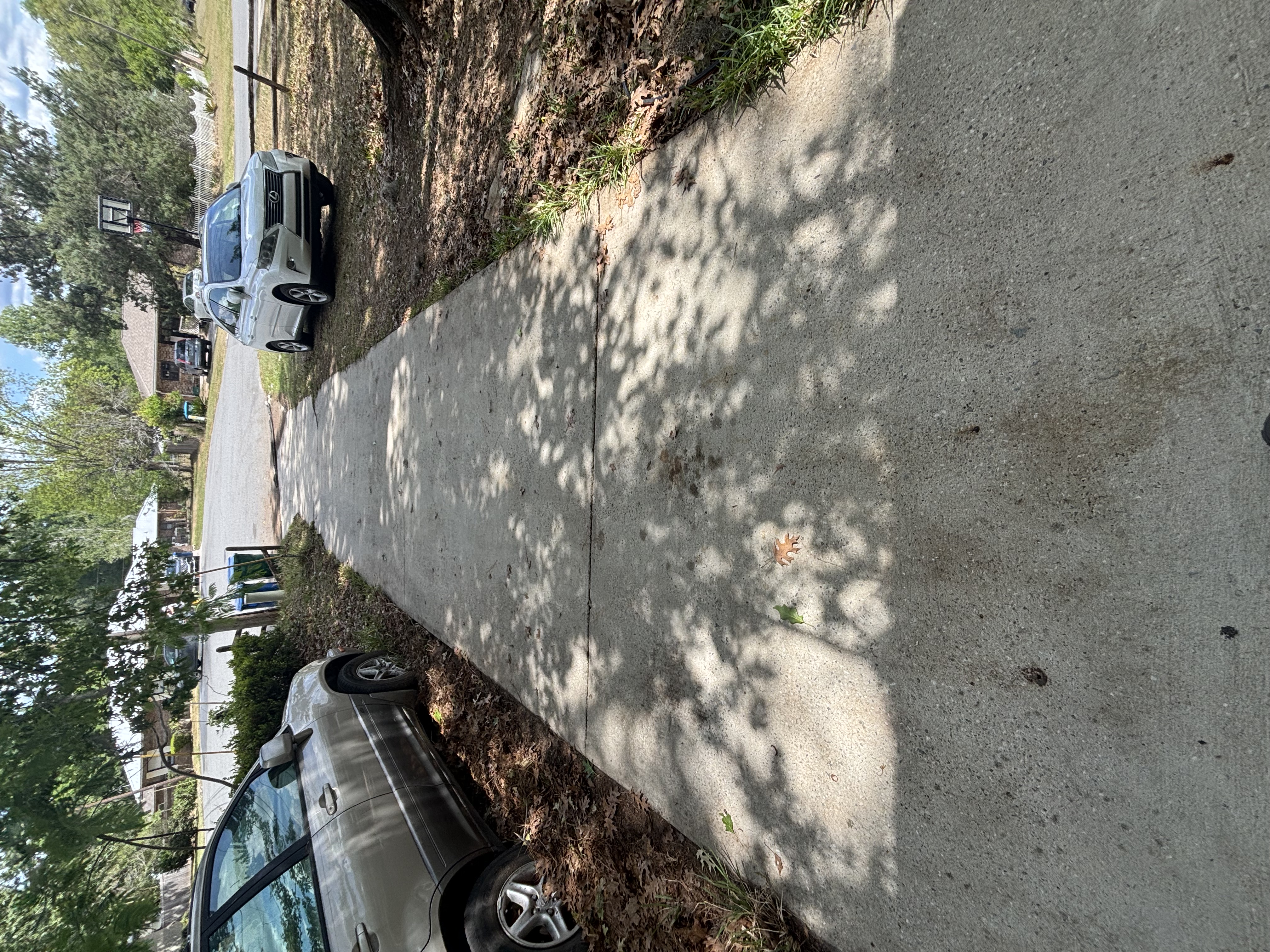 Close-up of a freshly cleaned wet concrete driveway surface with fine water droplets and detailed stone texture