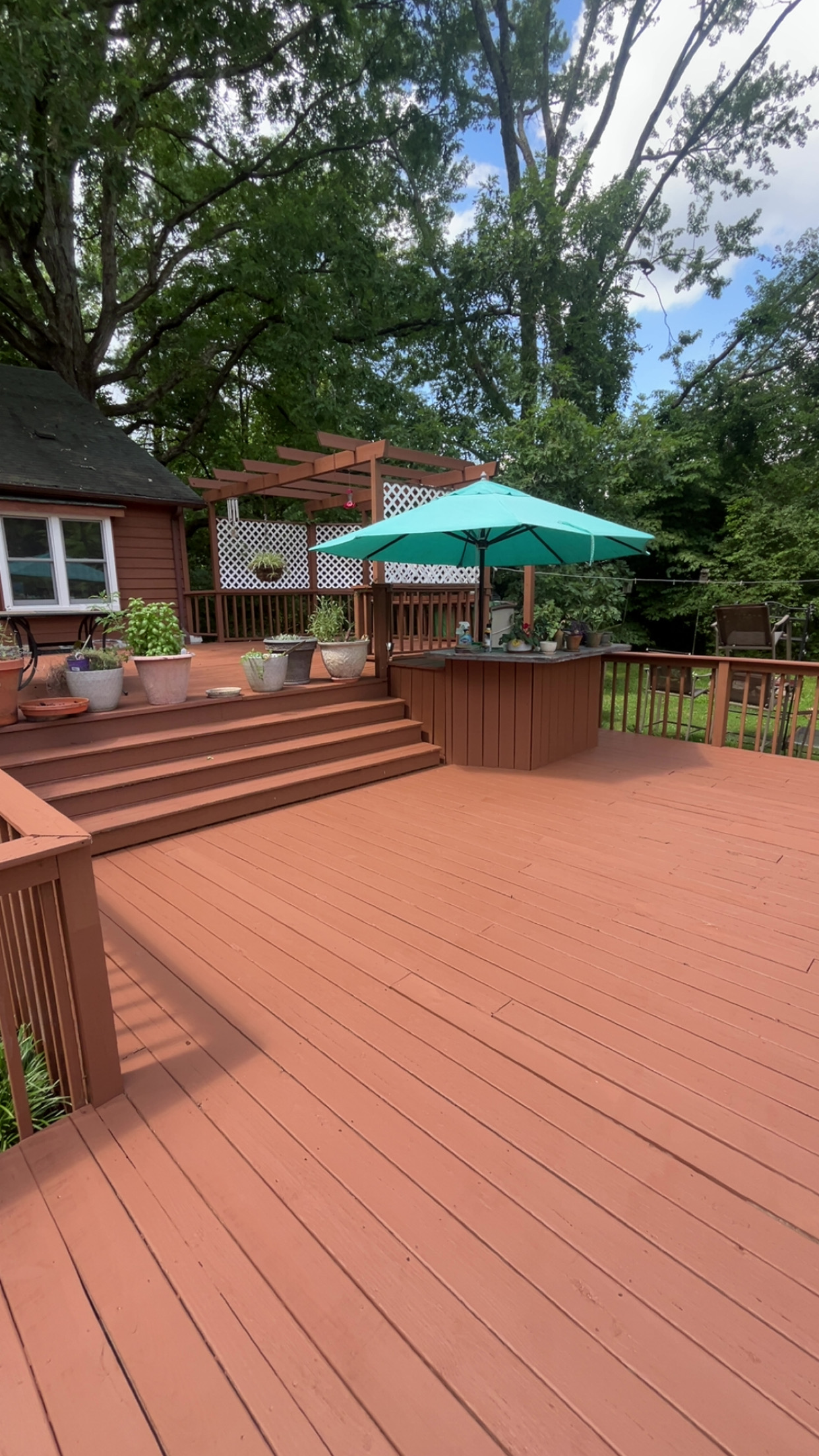 Freshly stained wooden backyard deck with rich brown protective finish