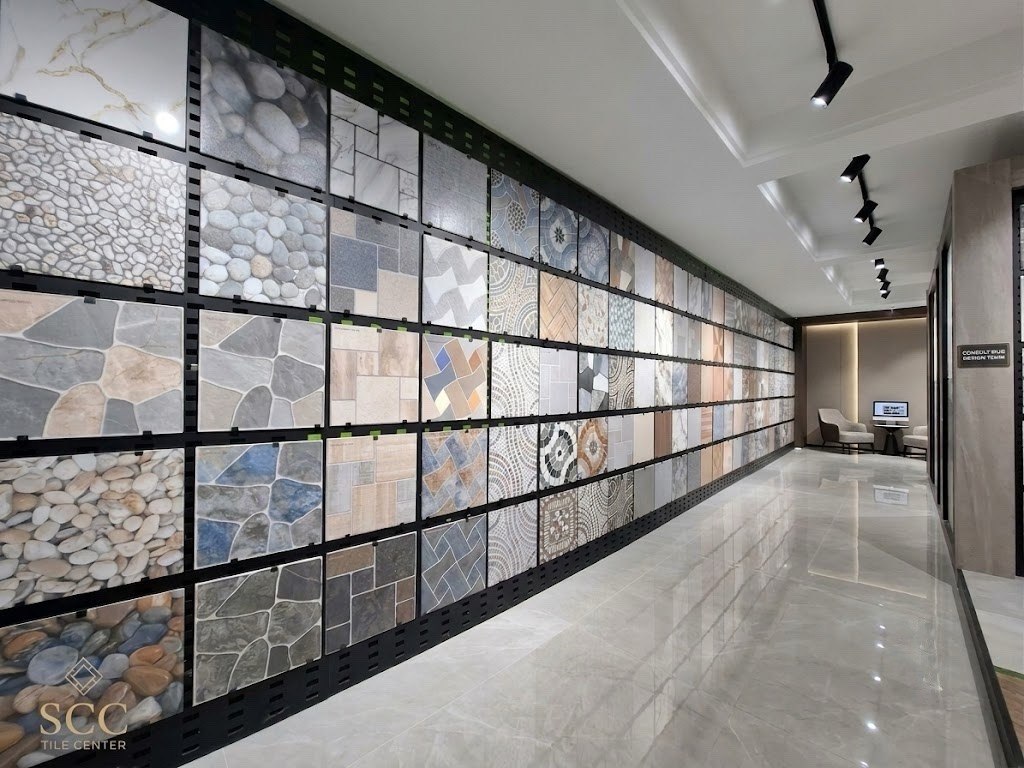 An architect and client discussing tile options in a modern, well-lit showroom